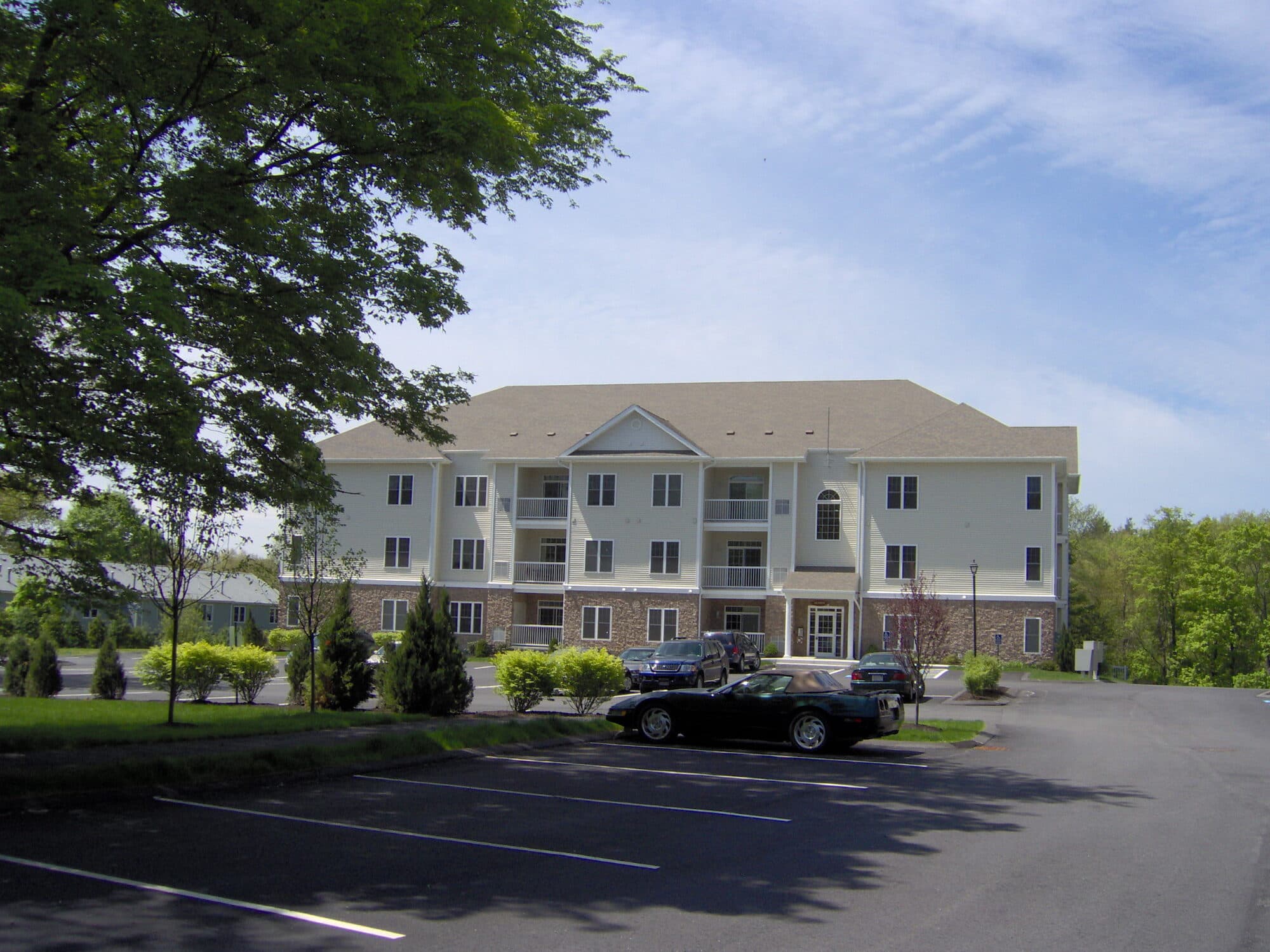 A residential building at Chestnut Park Apartments framed by mature trees